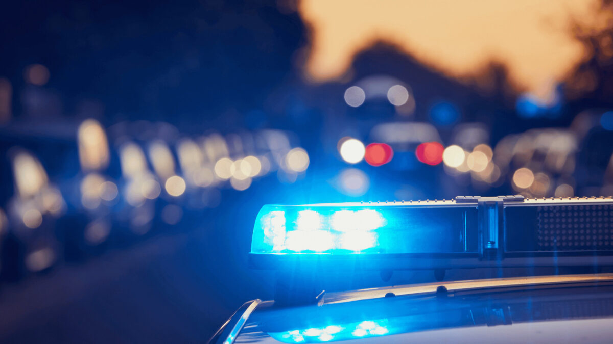 a close up of a police car with its lights on stopping a driver who bought a stolen vehicle from a dealership