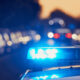 a close up of a police car with its lights on stopping a driver who bought a stolen vehicle from a dealership